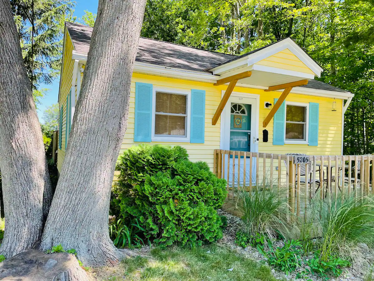Charming yellow cottage with turquoise shutters.